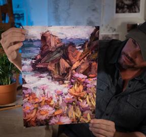 Sean Diediker fine art painter holding a print of a landscape from Big Sur episode of Canvasing The World TV show.