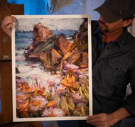 Painter Sean Diediker holding a fine art reproduction of his artwork from Canvasing The World Big Sur California.