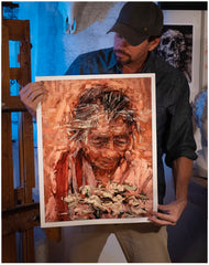 Painter Sean Diediker holding a fine art reproduction print of The Flower Woman based on an encounter with a local Balinese woman in Ubud Bali Indonesia.