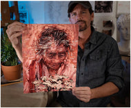 Artist Sean Diediker with a fine art reproduction print of The Flower Woman The Beggar Woman Ubud Bali Indonesia.