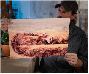 Painter Sean Diediker holding a print of his artwork Rice Field Workers he created after rising Bali Indonesia as shown on Canvasing The World with Sean Diediker.